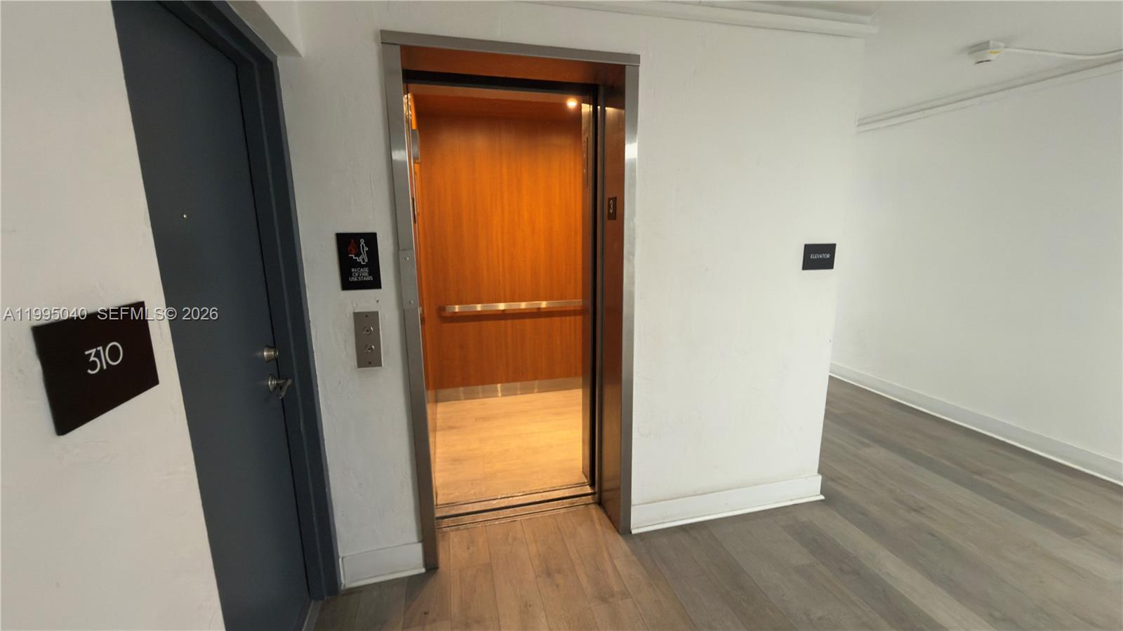 143 Southwest 9th Street, Unit 310 Miami, FL 33130 - Photo 20 of 20 a view of a hallway with wooden floor