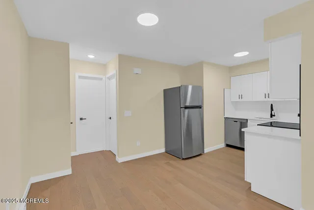 a kitchen with stainless steel appliances a refrigerator and a stove top oven