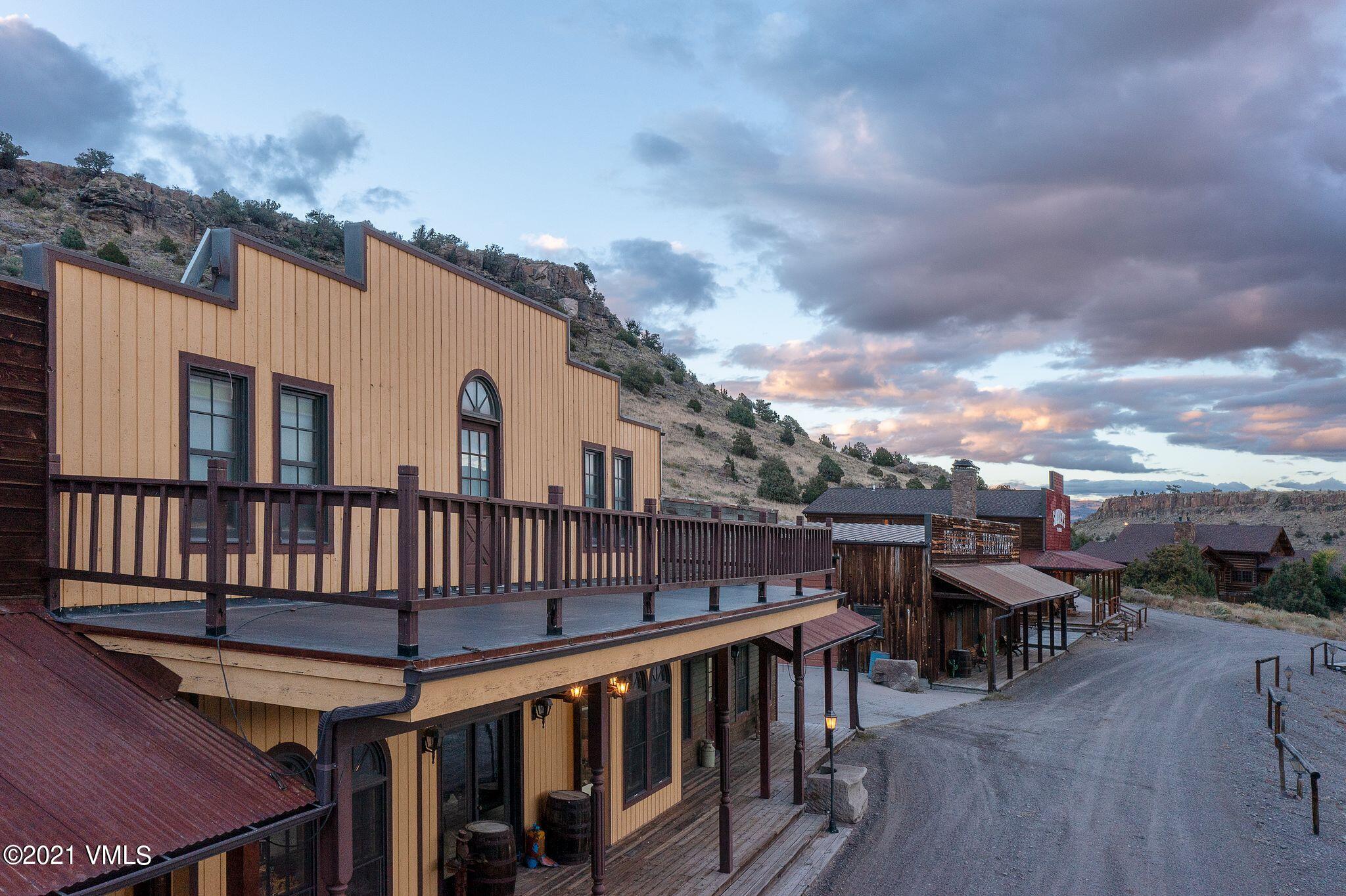 36710 County Rd CC 36 Saguache, CO 81149 - Photo 11 of 23 a view of a roof deck with table and chairs with wooden floor and fence