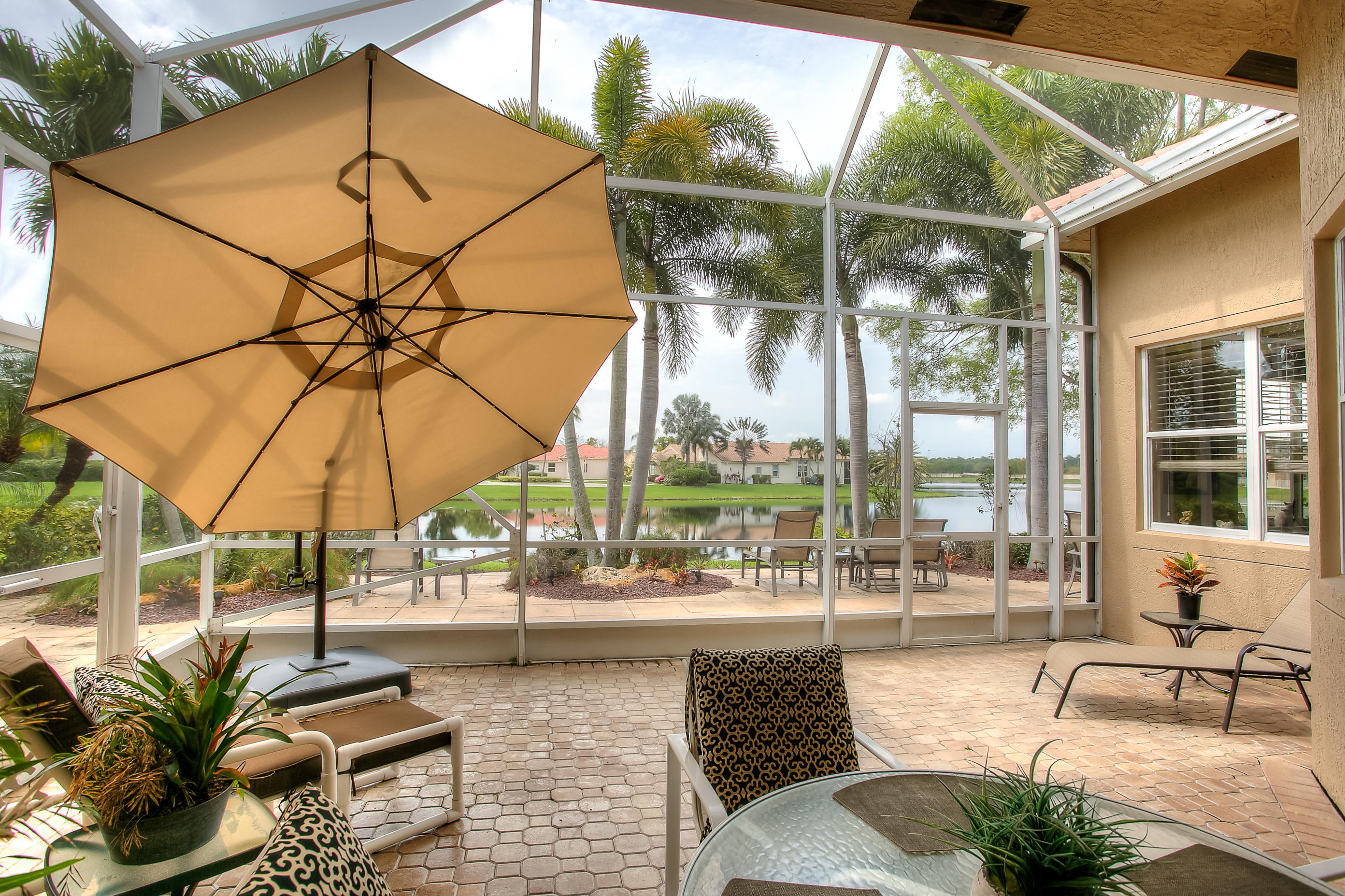 9748 Via Verga Street Lake Worth, FL 33467 - Photo 13 of 16 a view of a patio with a table and chairs