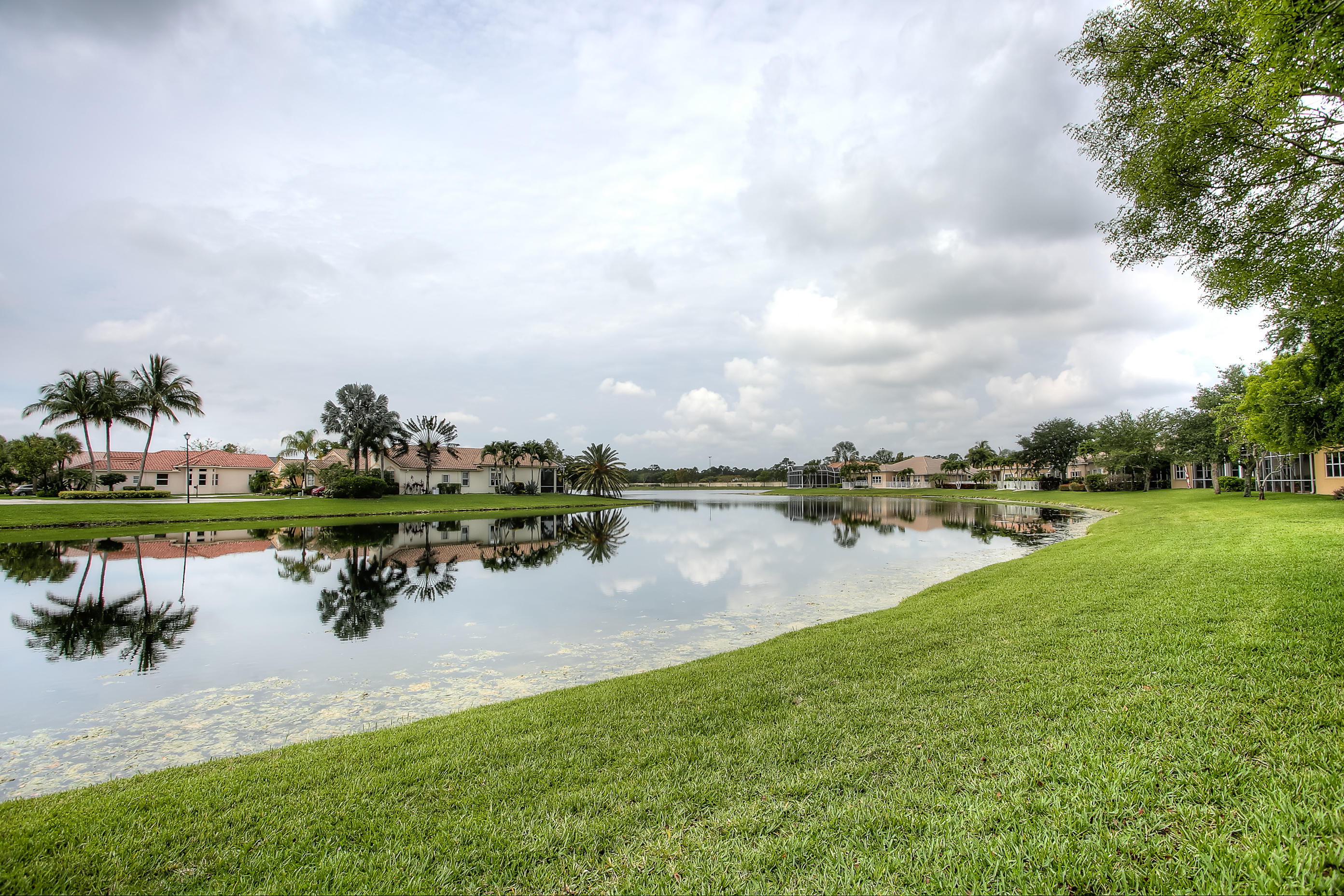 9748 Via Verga Street Lake Worth, FL 33467 - Photo 16 of 16 a view of a lake with houses in back