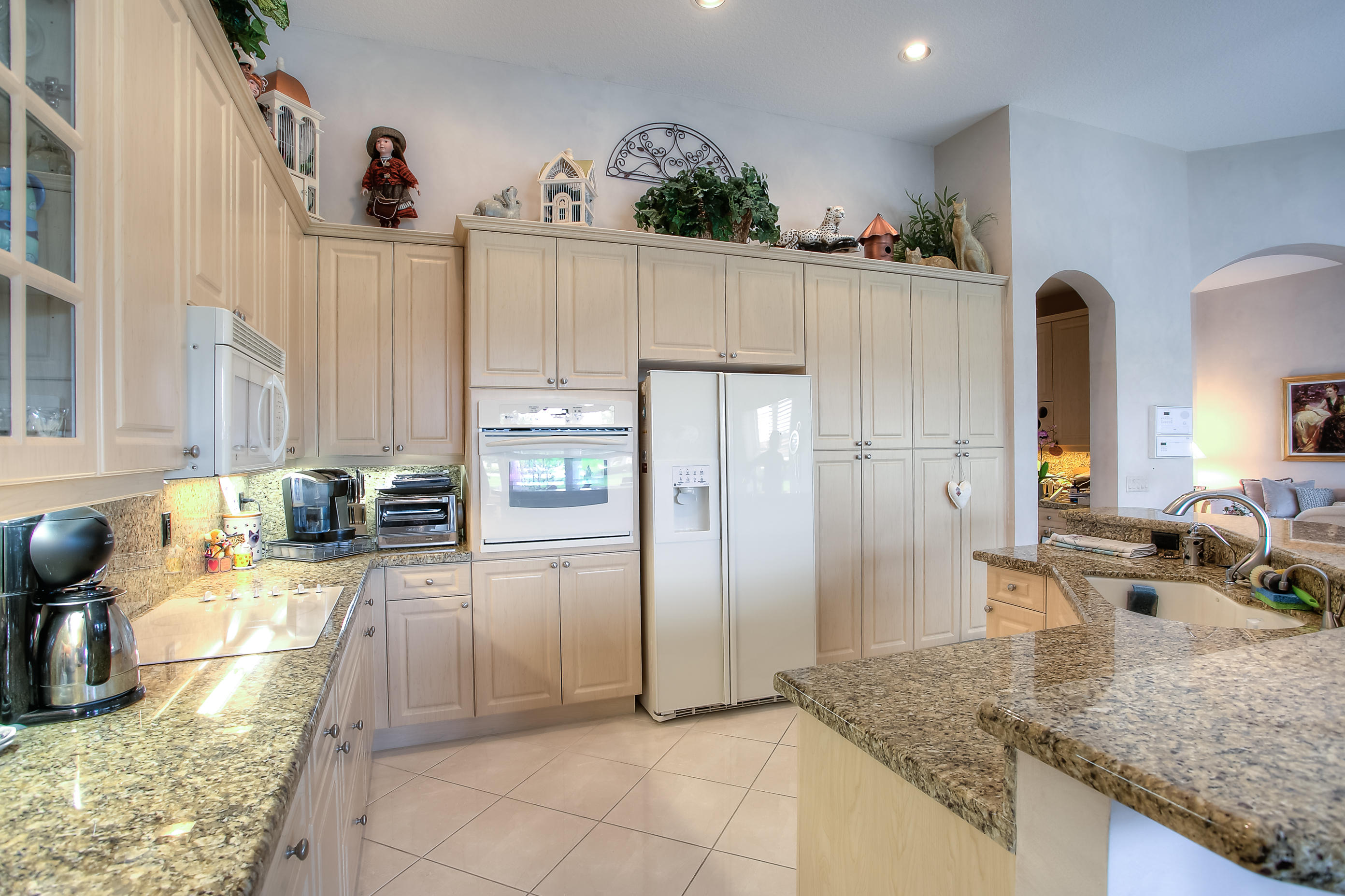 9748 Via Verga Street Lake Worth, FL 33467 - Photo 5 of 16 a kitchen with stainless steel appliances granite countertop a refrigerator and a sink