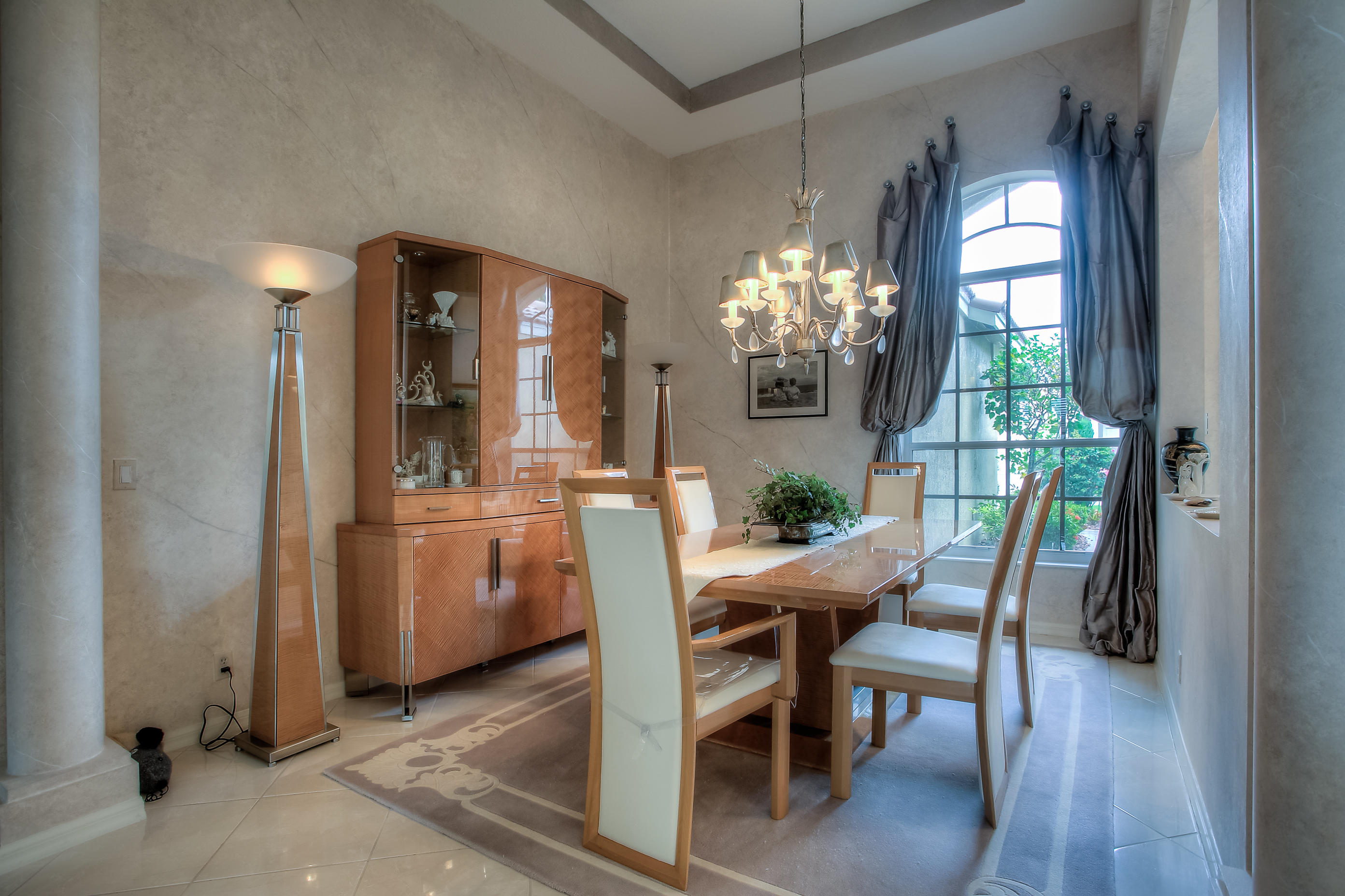 9748 Via Verga Street Lake Worth, FL 33467 - Photo 7 of 16 a view of a dining room with furniture and chandelier