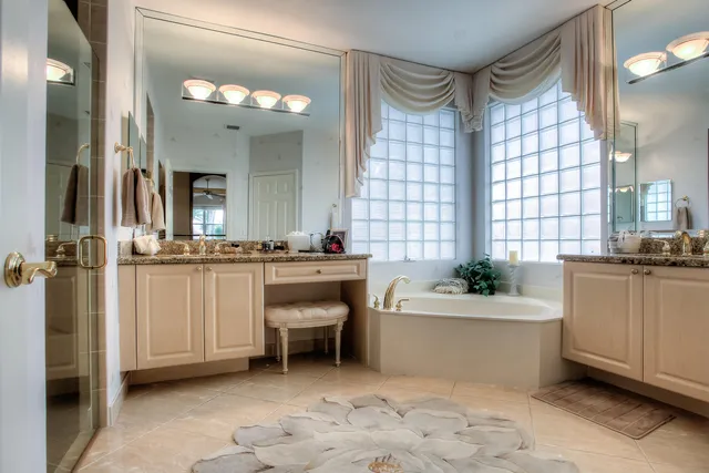 a bathroom with a bathtub sink and mirror