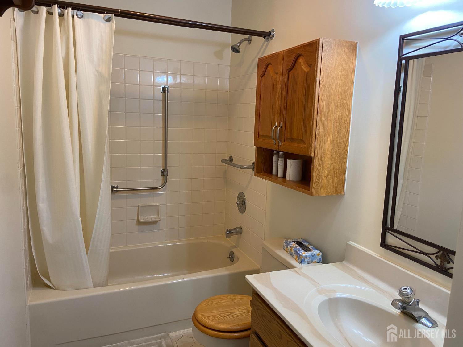 8 Benjamin Franklin Drive, Unit C Monroe Township, NJ 08831 - Photo 5 of 9 a bathroom with a sink toilet and shower