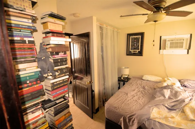 a bedroom with a bed and a window