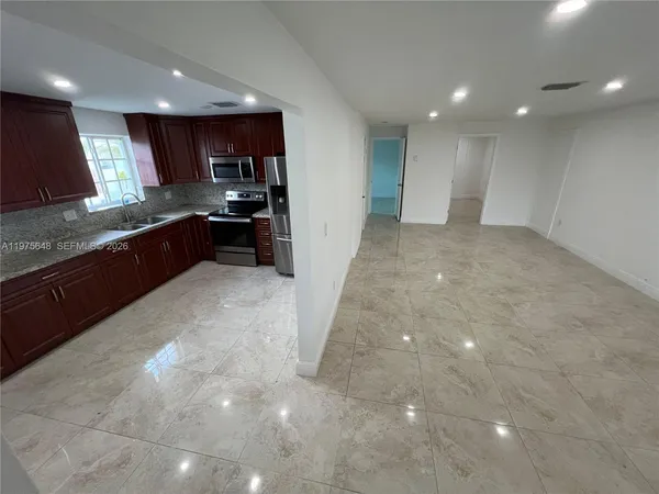 a large kitchen with stainless steel appliances lots of counter top space