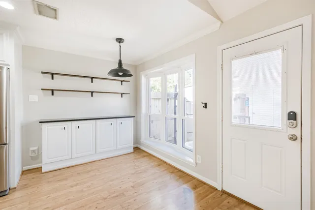 en empty room with wooden floor and cabinet