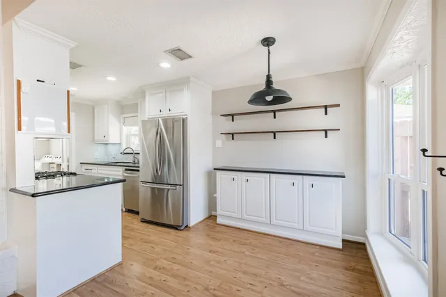 a kitchen with stainless steel appliances granite countertop a refrigerator and a sink