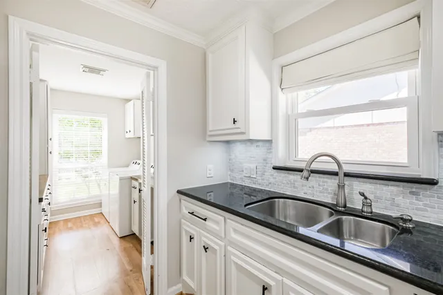 a view of a kitchen sink and a cabinet