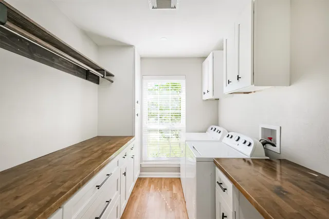 a kitchen with a stove and white cabinets