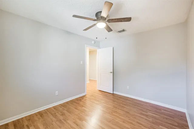 a bathroom with a granite countertop sink a mirror and a toilet