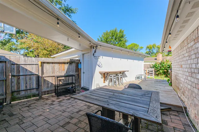 a view of a house with a yard and a large tree