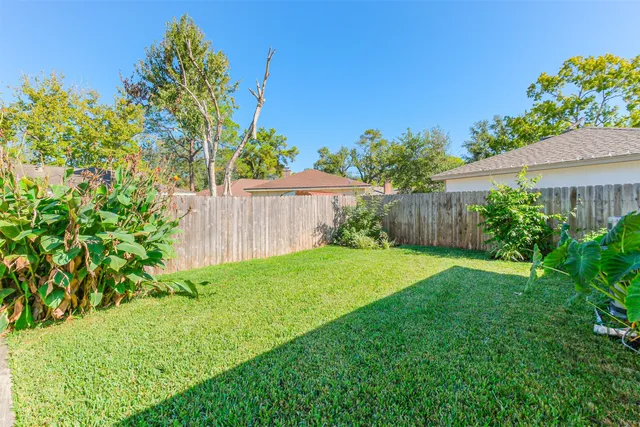 a view of a house with a yard and a garden