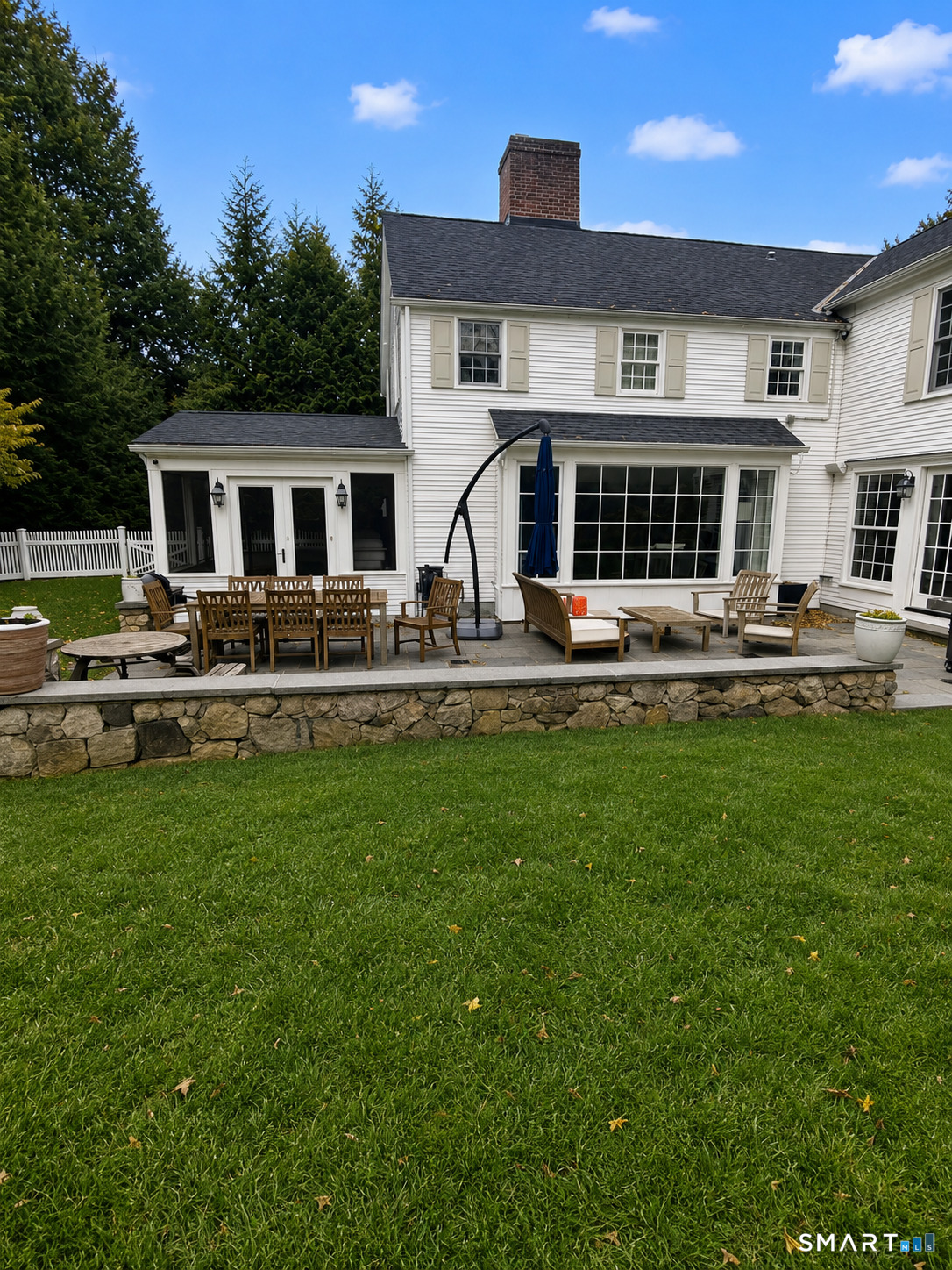 142 Brookside Road Darien, CT 06820 - Photo 15 of 18 a front view of a house with garden and trees