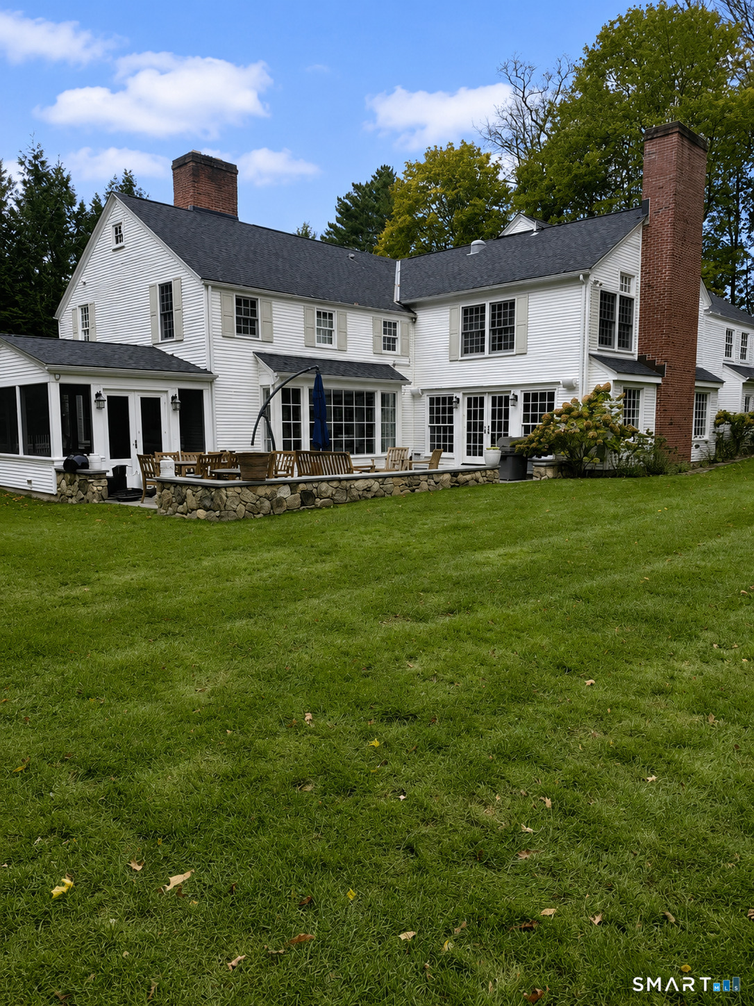 142 Brookside Road Darien, CT 06820 - Photo 16 of 18 a front view of a house with a garden