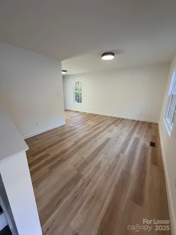 a view of an empty room and wooden floor