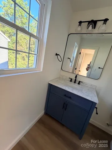 a bathroom with a double vanity sink and a mirror