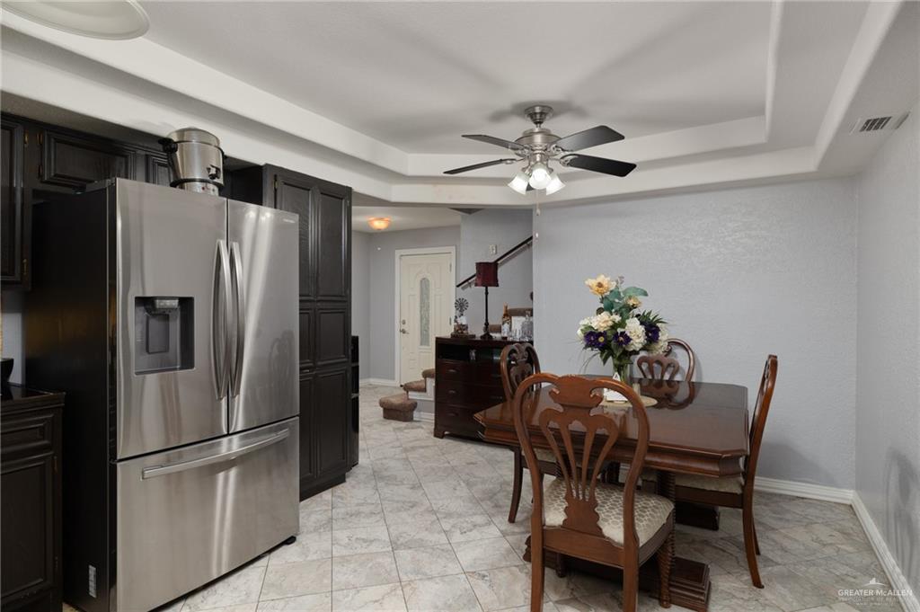 26813 Solis Road La Feria, TX 78559 - Photo 11 of 33 a kitchen with stainless steel appliances a refrigerator a table and chairs
