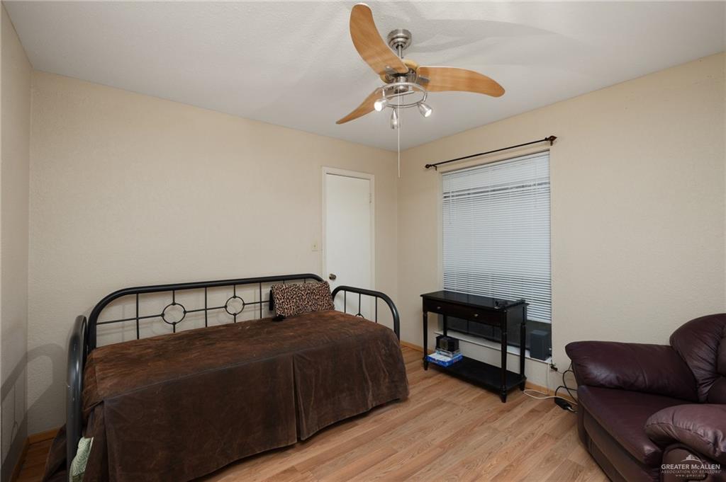 26813 Solis Road La Feria, TX 78559 - Photo 12 of 33 a bedroom with a bed a couch and chandelier