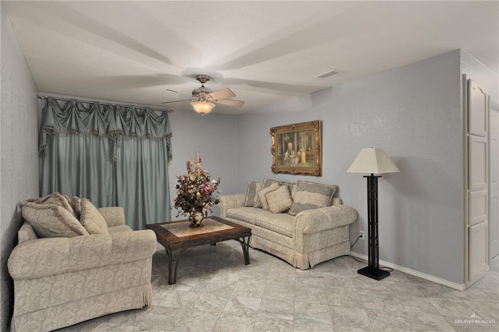 26813 Solis Road La Feria, TX 78559 - Photo 14 of 33 a living room with furniture and a chandelier