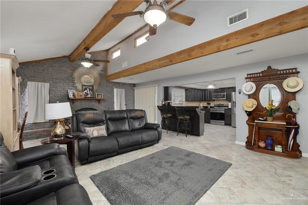 26813 Solis Road La Feria, TX 78559 - Photo 2 of 33 a living room with furniture and a flat screen tv