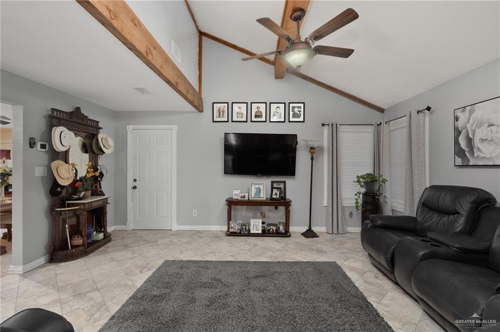 26813 Solis Road La Feria, TX 78559 - Photo 3 of 33 a living room with furniture a flat screen tv and a wall painting
