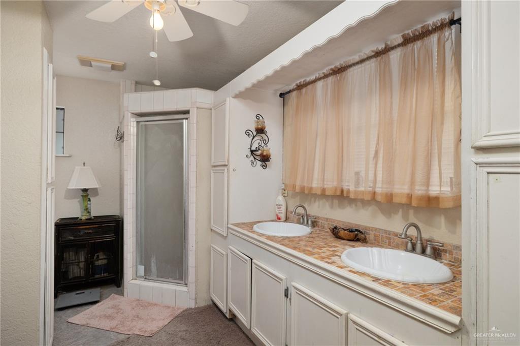 26813 Solis Road La Feria, TX 78559 - Photo 7 of 33 a bathroom with a double vanity sink and a mirror