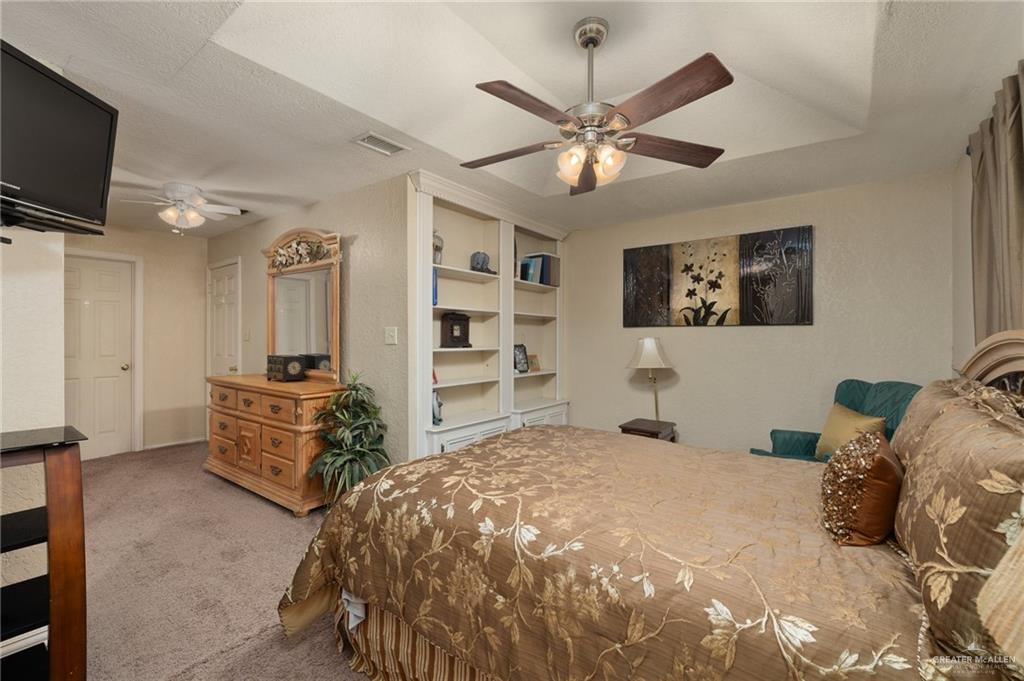 26813 Solis Road La Feria, TX 78559 - Photo 9 of 33 a bedroom with a bed and a flat screen tv