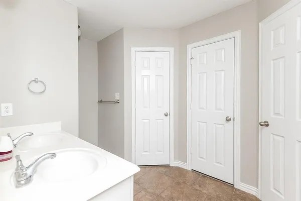 a bathroom with a sink vanity and tub