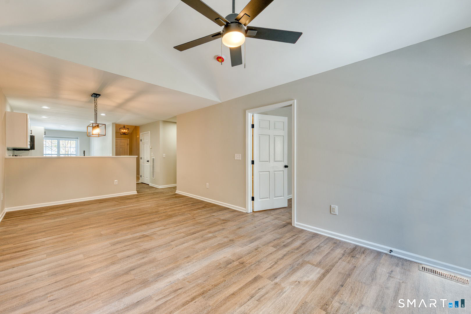 159 Jennifer Lane, Unit 159 Newtown, CT 06482 - Photo 6 of 28 a view of an empty room with window and wooden floor