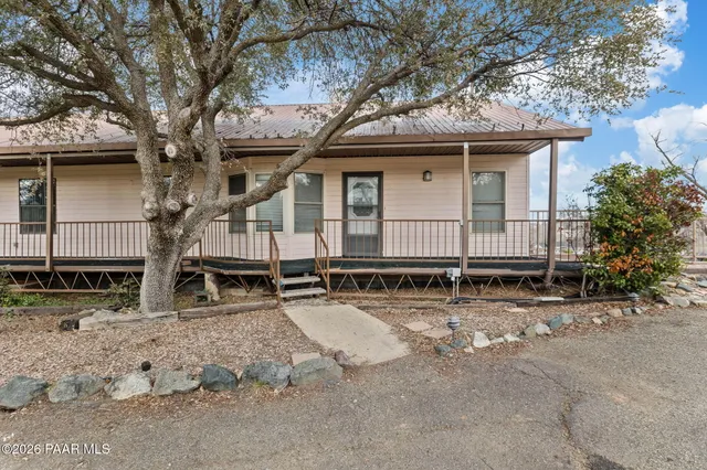 an empty room with a window and a ceiling fan