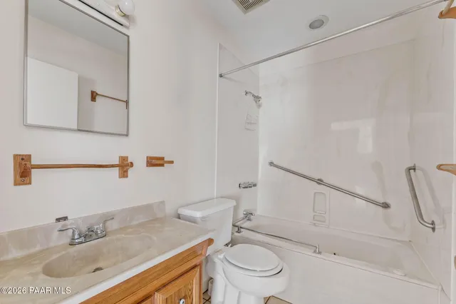 an empty room with a ceiling fan and a window