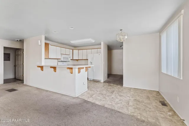 a view of an empty room with a ceiling fan