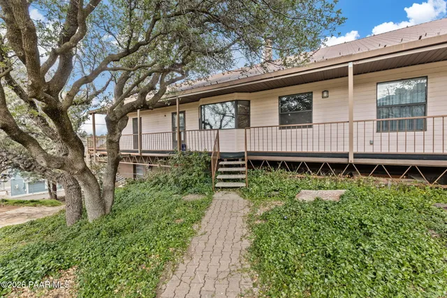 a backyard of a house with a garden and deck