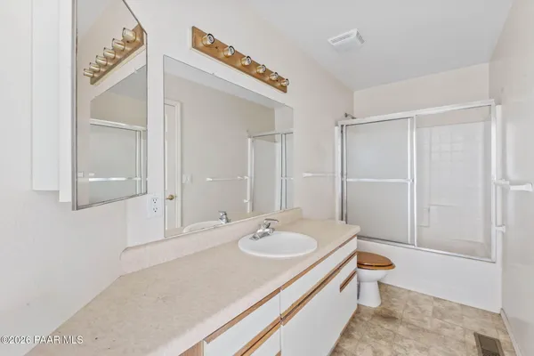 a view of a house with a yard covered with snow in front of house