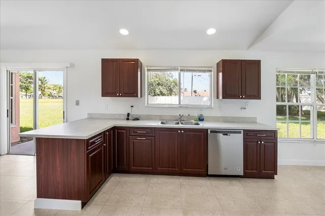 a kitchen with stainless steel appliances granite countertop a sink stove and cabinets