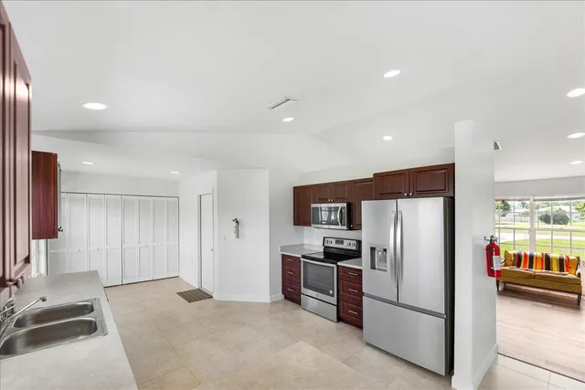 a kitchen with stainless steel appliances a refrigerator and a sink