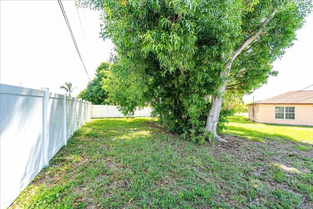 a view of backyard with swimming pool