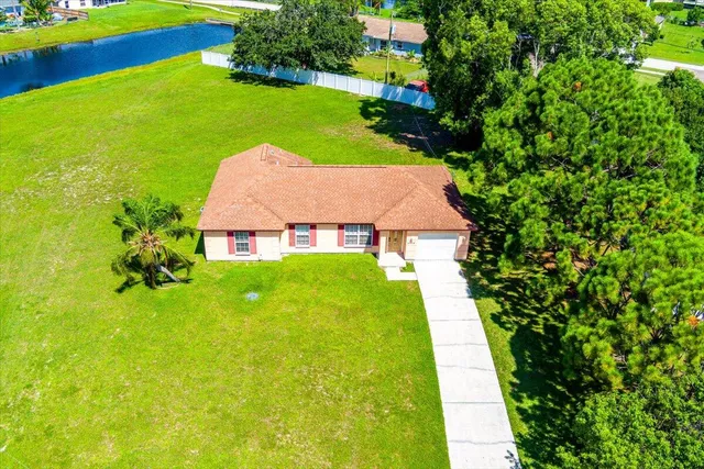 an aerial view of a residential houses with swimming pool and outdoor space
