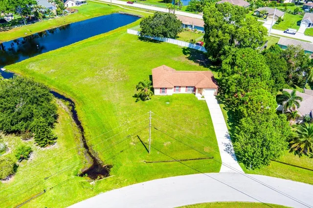 an aerial view of a residential houses with swimming pool and outdoor space
