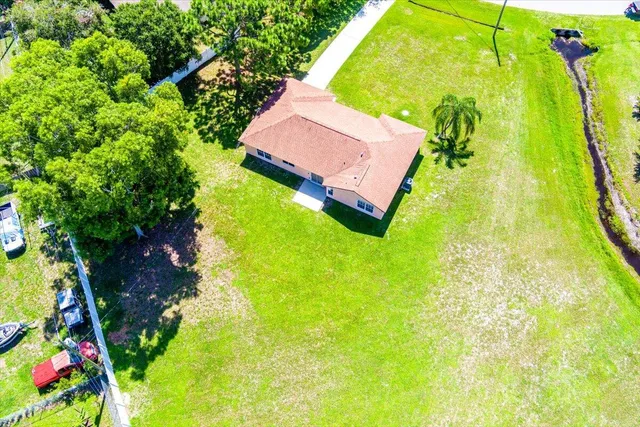 an aerial view of a house with a swimming pool