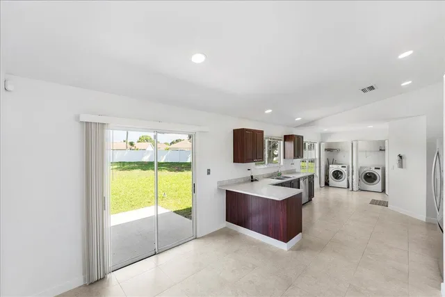 a living room with kitchen furniture and a flat screen tv