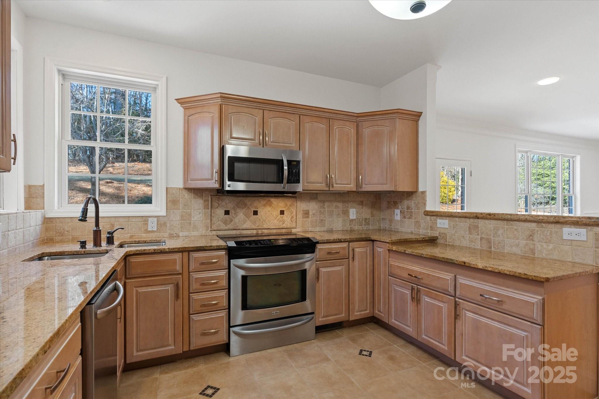 5774 Crown Terrace Hickory, NC 28601 - Photo 20 of 48 a kitchen with stainless steel appliances granite countertop white cabinets a sink and a stove