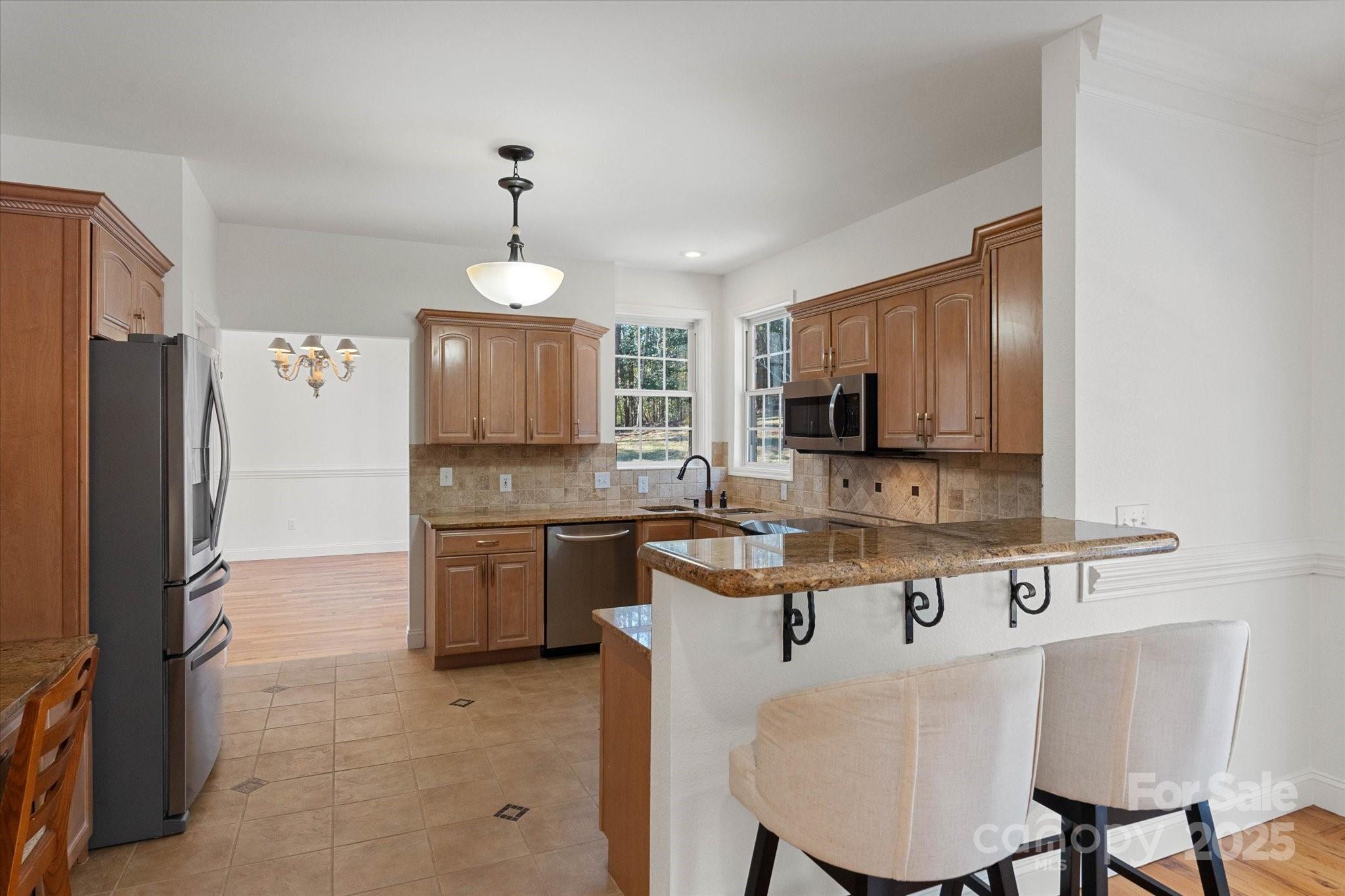 5774 Crown Terrace Hickory, NC 28601 - Photo 21 of 48 a kitchen with stainless steel appliances granite countertop a stove refrigerator sink and cabinets