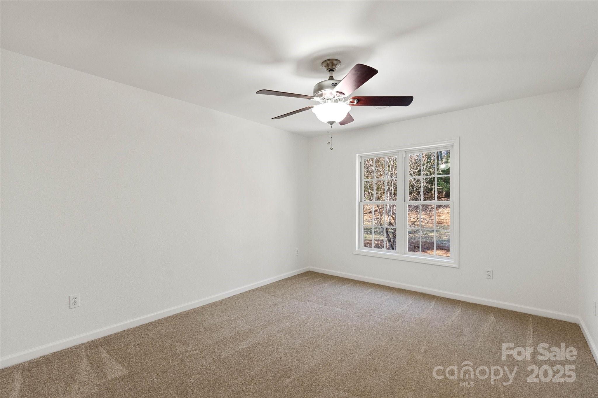 5774 Crown Terrace Hickory, NC 28601 - Photo 38 of 48 an empty room with a window and a fan