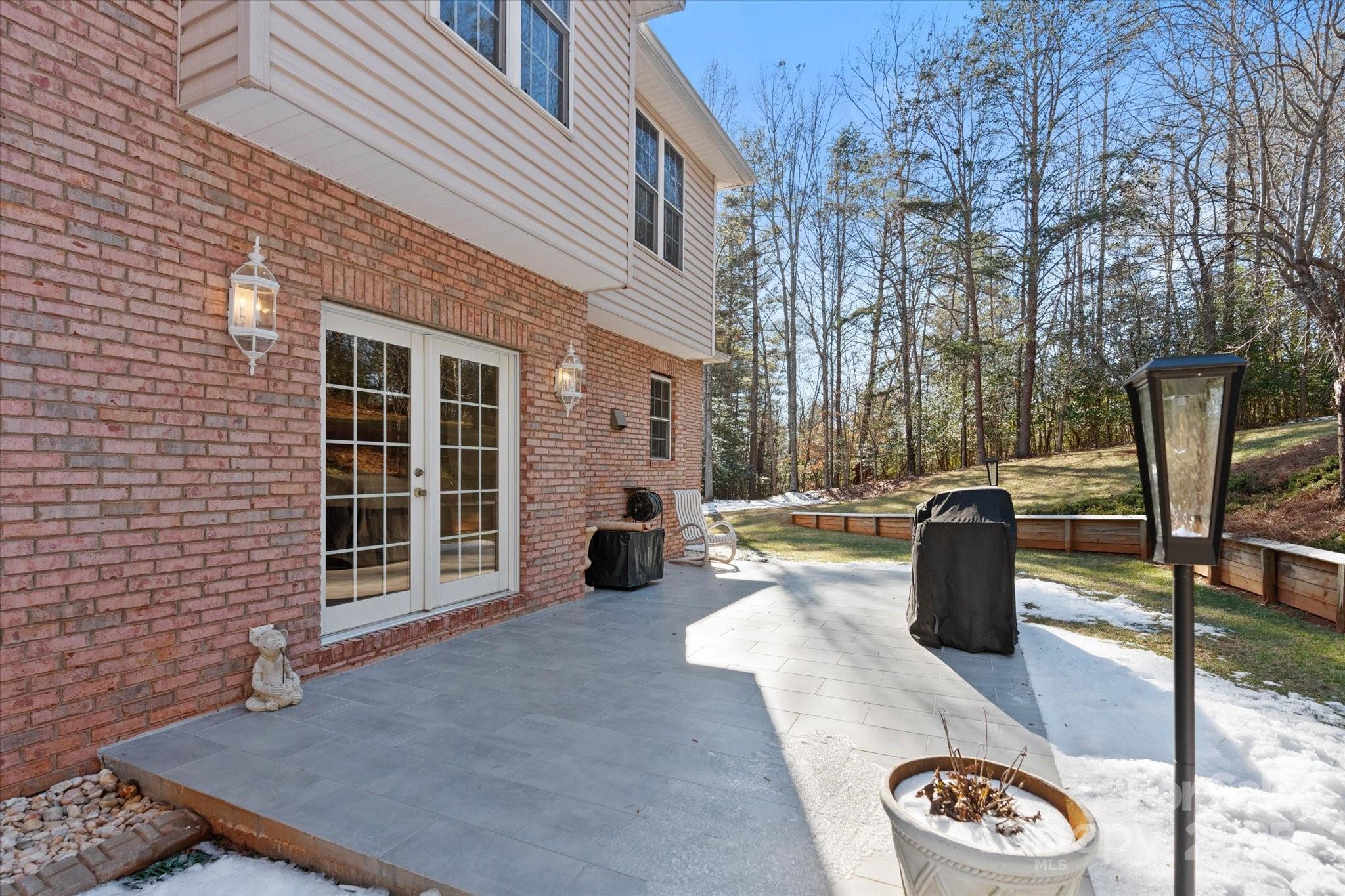 5774 Crown Terrace Hickory, NC 28601 - Photo 47 of 48 a view of a patio with couches table and chairs and potted plants