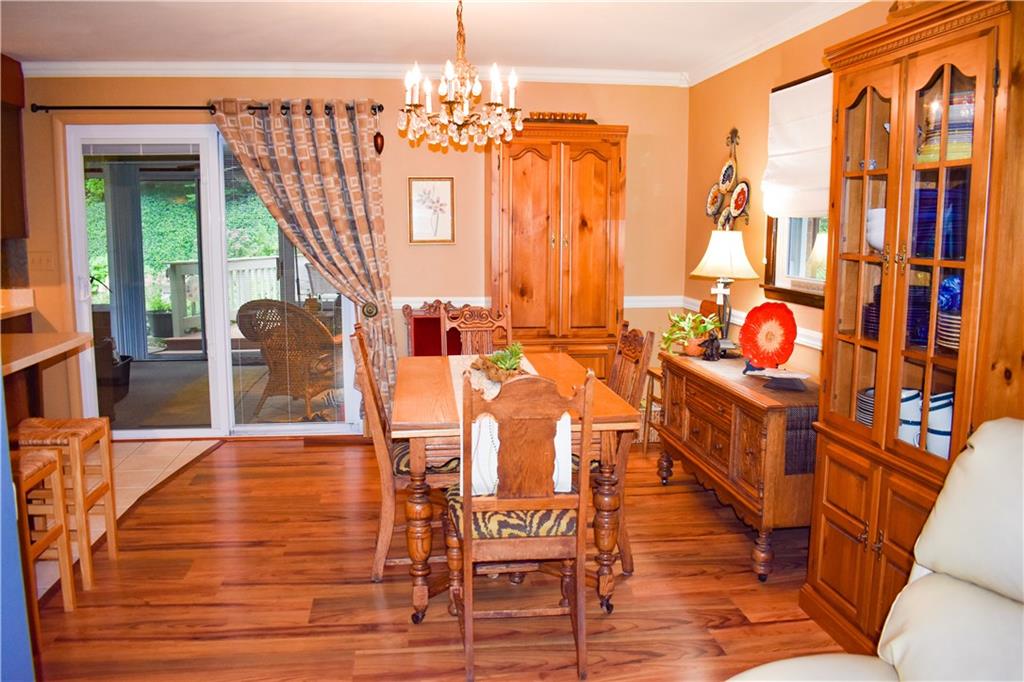 113 Morningside Drive Butler, PA 16002 - Photo 4 of 25 The living room flows into the spacious dining room and kitchen area, with of a view of the sunroom in the rear. Crown moulding adds classic detailing with windows all around to bring the outside in.