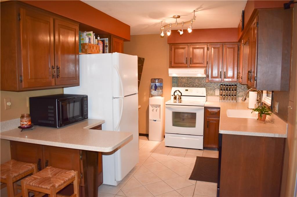 113 Morningside Drive Butler, PA 16002 - Photo 6 of 25 Tiled flooring, rich cabinetry, convenient island can serve as a breakfast bar or a great buffet area for entertaining.