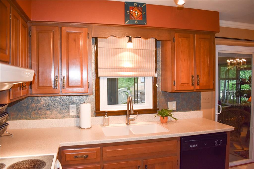 113 Morningside Drive Butler, PA 16002 - Photo 7 of 25 Newer windows throughout and a new sliding glass door too! New kitchen faucet and a nice view of the Corian counters with integrated sink, and new faucet. Custom painted backsplash too. Cooking and entertaining are going to be a delight!